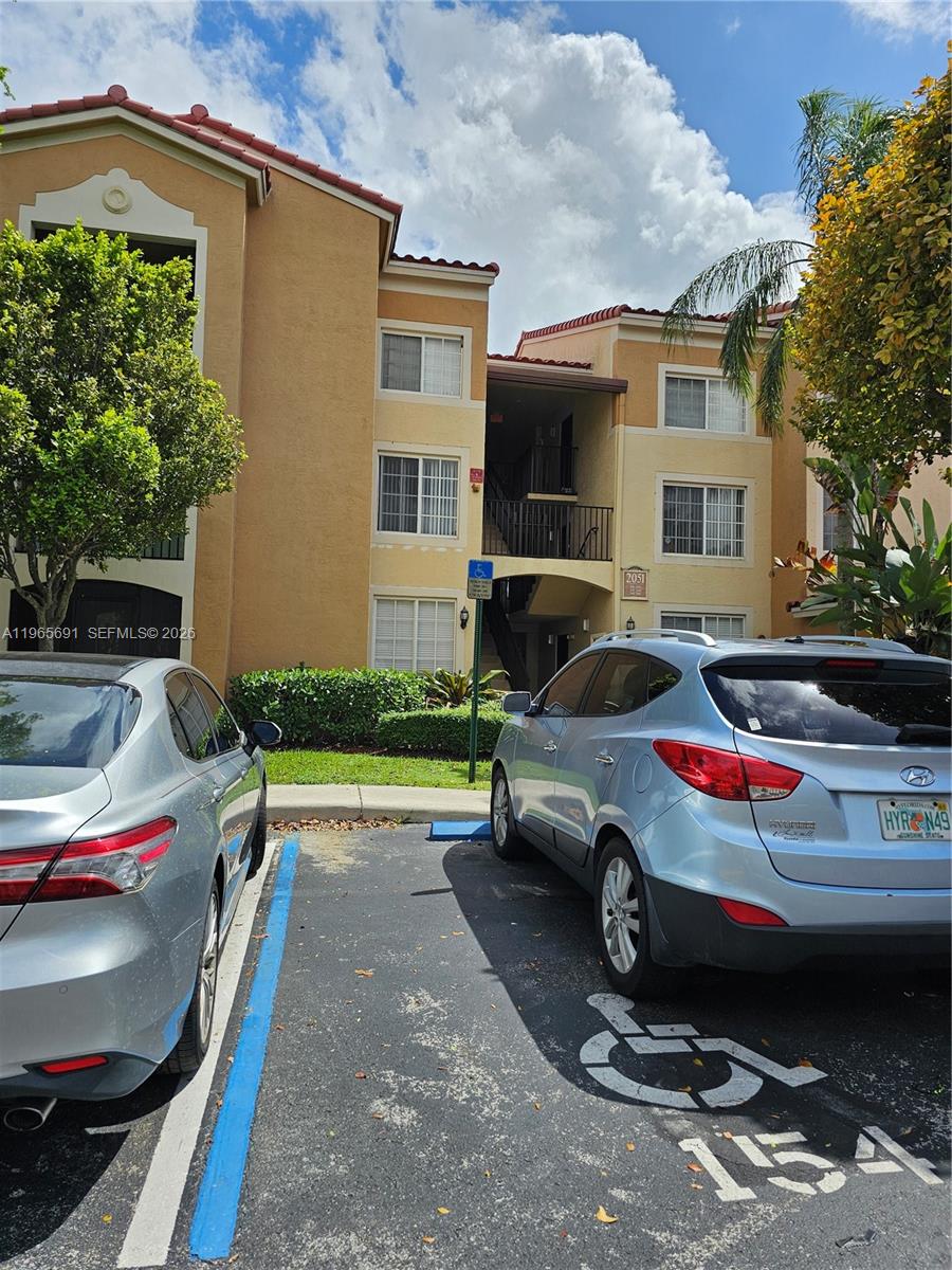 2051 Renaissance Boulevard, Unit 104 Miramar, FL 33025 - Photo 3 of 39 a front view of a house with cars parked
