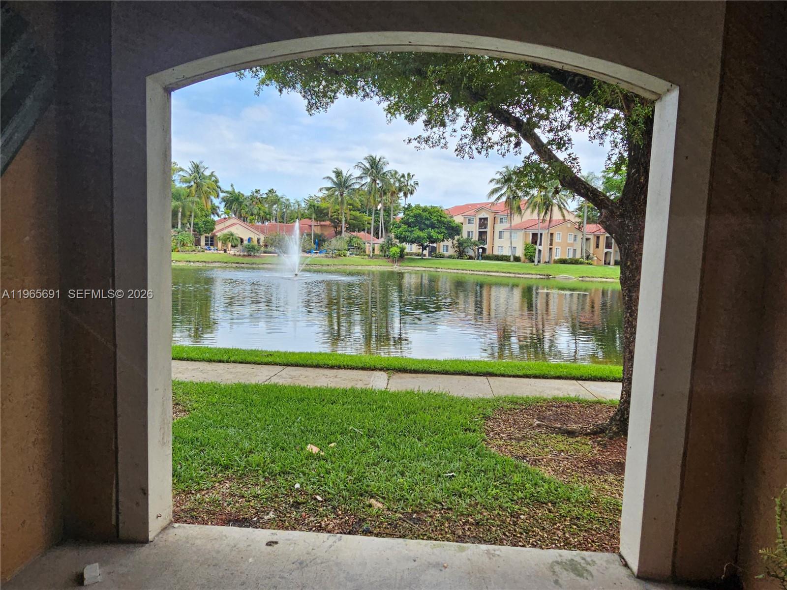 2051 Renaissance Boulevard, Unit 104 Miramar, FL 33025 - Photo 31 of 39 a view of a lake with a big yard