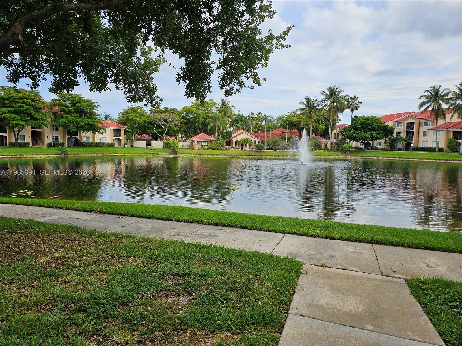 2051 Renaissance Boulevard, Unit 104 Miramar, FL 33025 - Photo 34 of 39 a view of a lake with a park