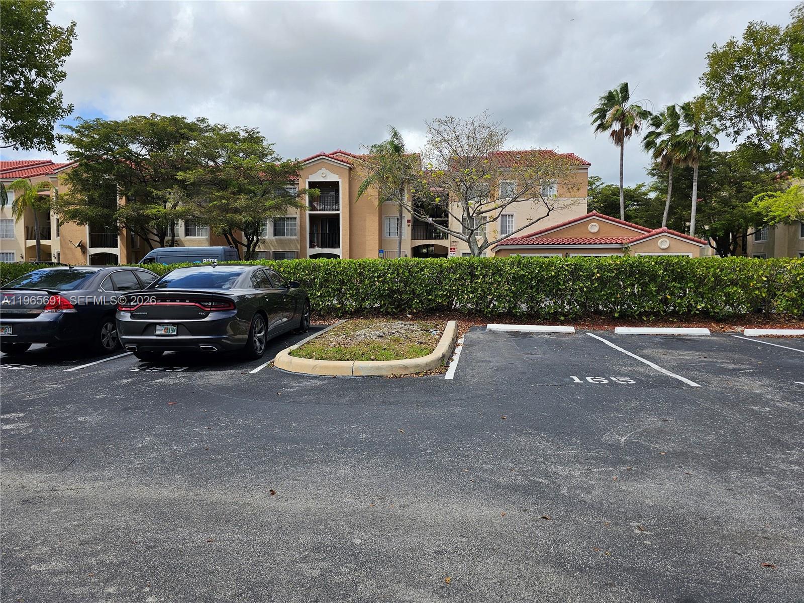 2051 Renaissance Boulevard, Unit 104 Miramar, FL 33025 - Photo 8 of 39 a view of a street with a car parked in front of it