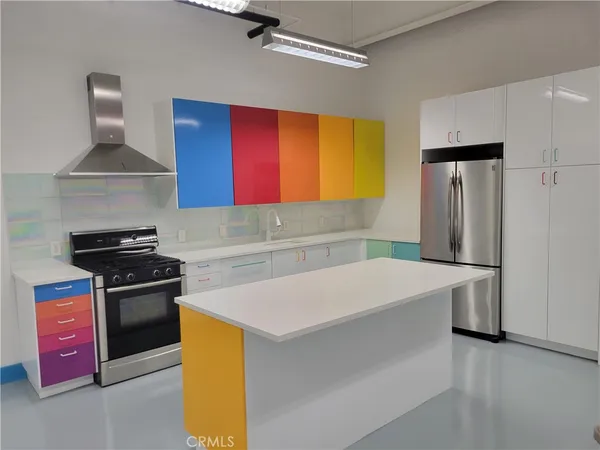 a kitchen with stainless steel appliances a stove a refrigerator and a sink