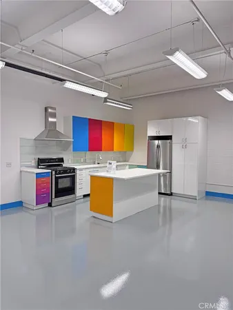 a kitchen with stainless steel appliances granite countertop a sink dishwasher and a stove