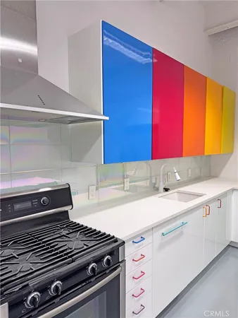 a kitchen with a sink cabinets and appliances
