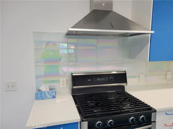 a stove top oven sitting inside of a kitchen