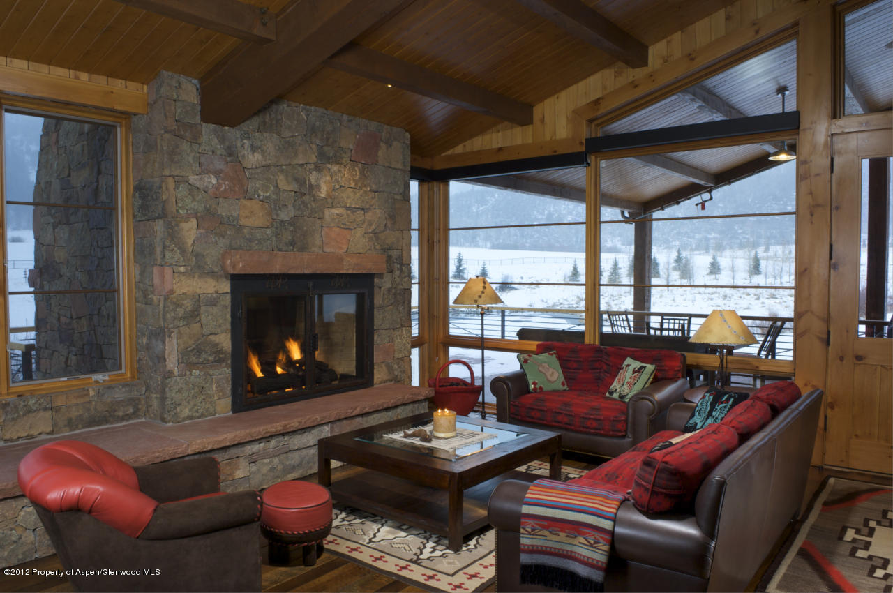 2900 Taylor Creek Road Basalt, CO 81621 - Photo 21 of 39 a living room with furniture a fireplace a lamp and a large window