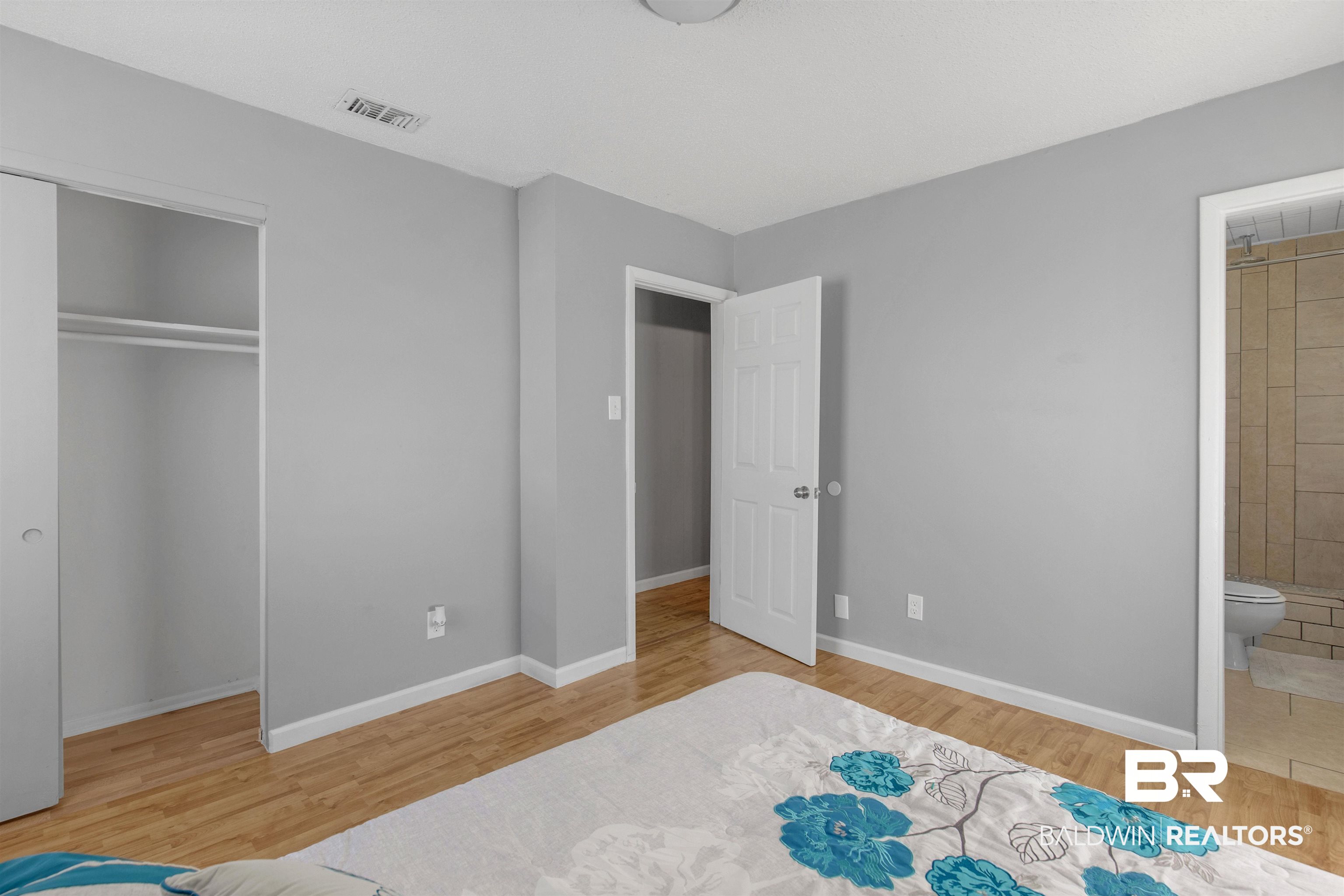 501 West Craig Street Atmore, AL 36502 - Photo 15 of 26 Bedroom featuring light hardwood / wood-style flooring, ensuite bath, and a closet
