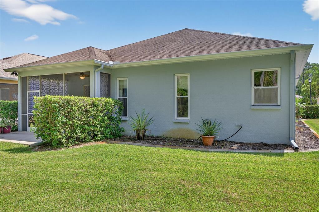 11501 Bloomington Court New Port Richey, FL 34654 - Photo 19 of 71 a front view of a house with a yard and potted plants