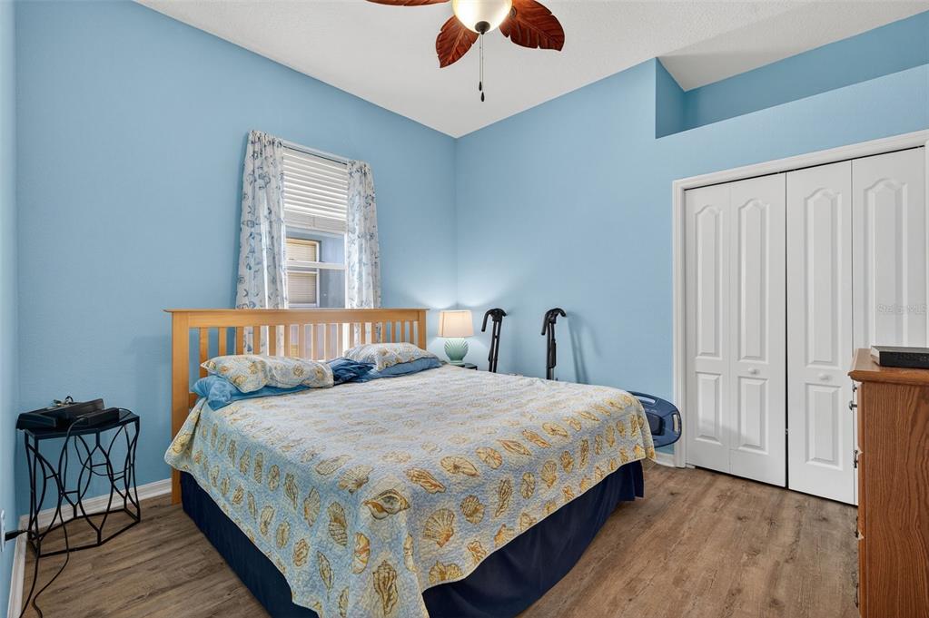 11501 Bloomington Court New Port Richey, FL 34654 - Photo 25 of 71 a bedroom with a large bed and a chandelier