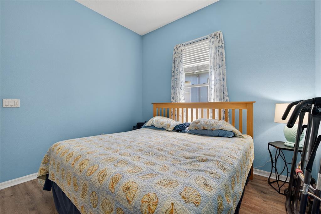 11501 Bloomington Court New Port Richey, FL 34654 - Photo 27 of 71 a bedroom with a bed a dresser and wooden floor