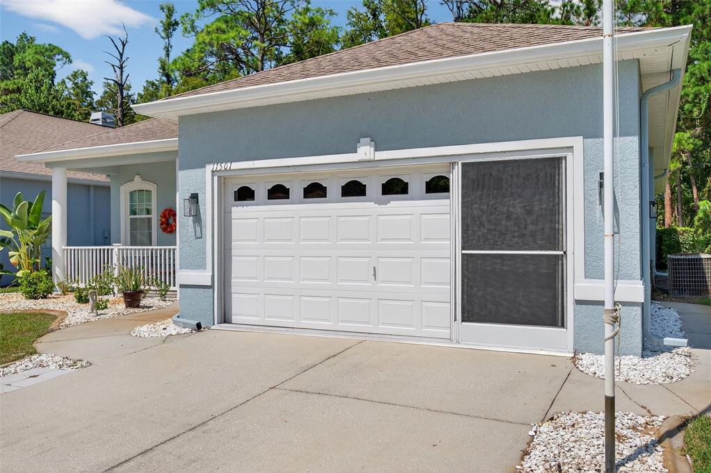 11501 Bloomington Court New Port Richey, FL 34654 - Photo 3 of 71 a front view of a house with garage