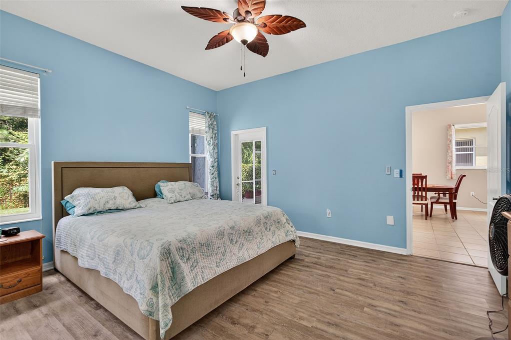 11501 Bloomington Court New Port Richey, FL 34654 - Photo 53 of 71 a bedroom with a large bed chandelier and a window