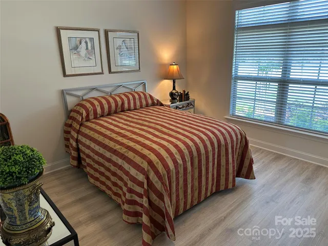 a bedroom with a bed and a potted plant