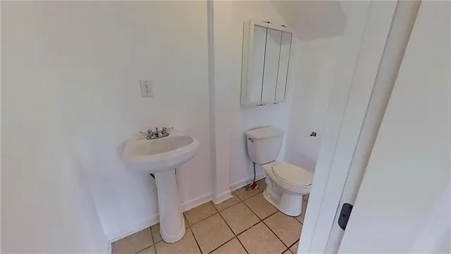 a bathroom with a sink toilet and a mirror