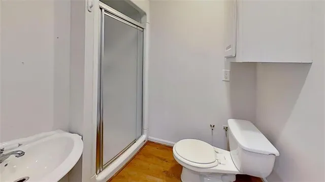 a white toilet sitting next to a bathroom sink