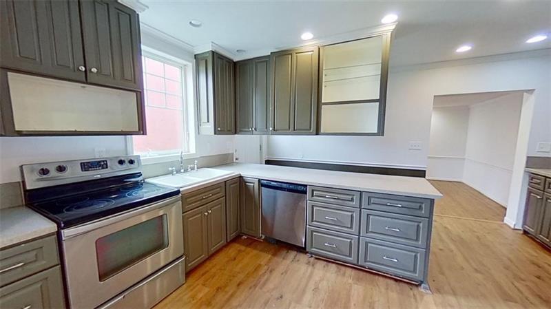 120 South 12th Street Pittsburgh, PA 15203 - Photo 3 of 19 a kitchen with wooden cabinets and a sink