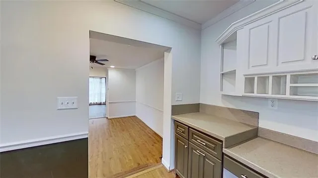 a kitchen with white cabinets and a stove top oven