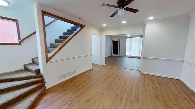 a view of entryway and hall with wooden floor