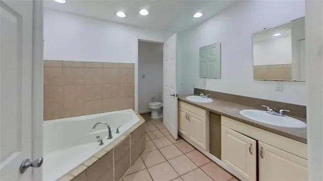 a spacious bathroom with a sink and mirror