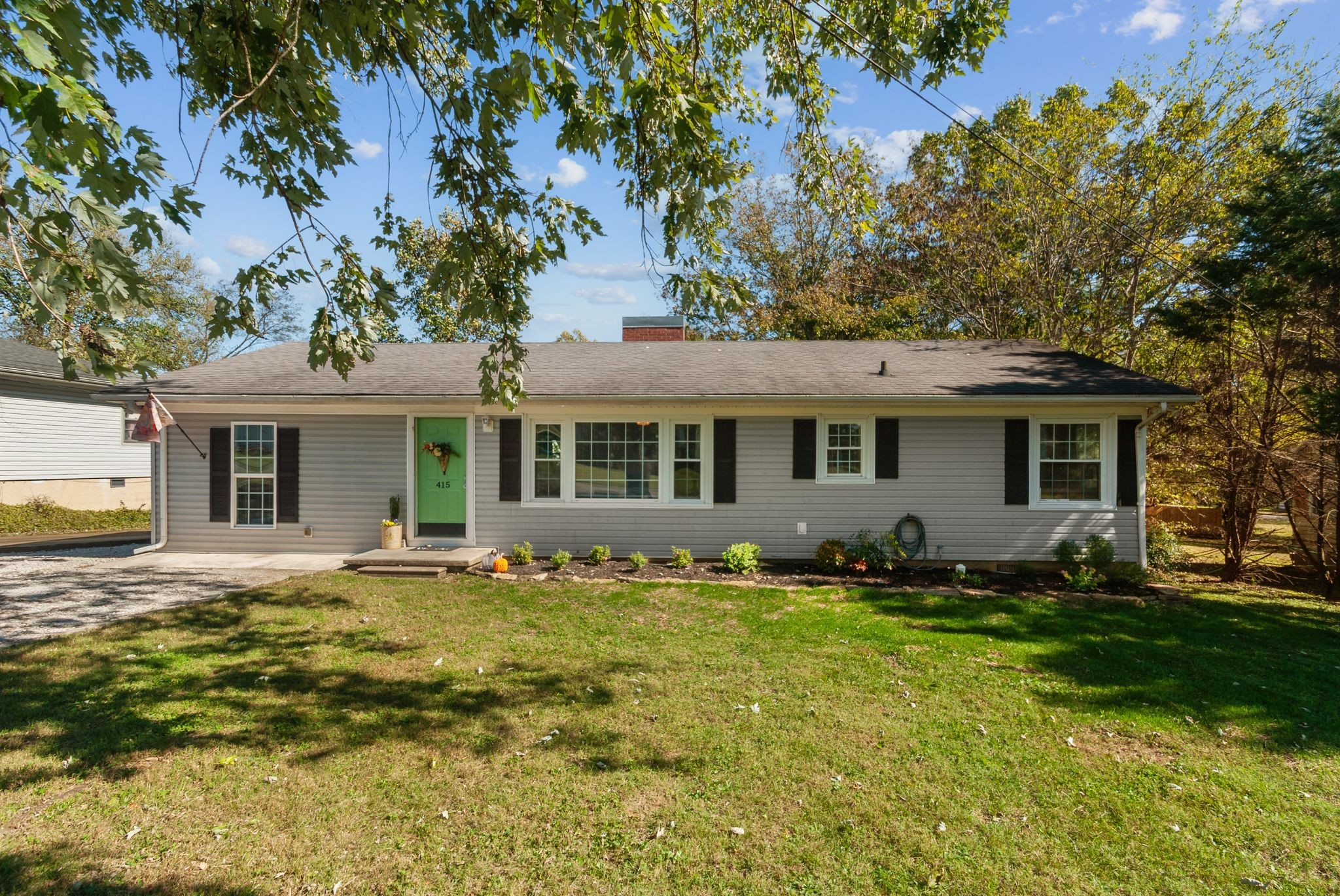 a front view of a house with a garden