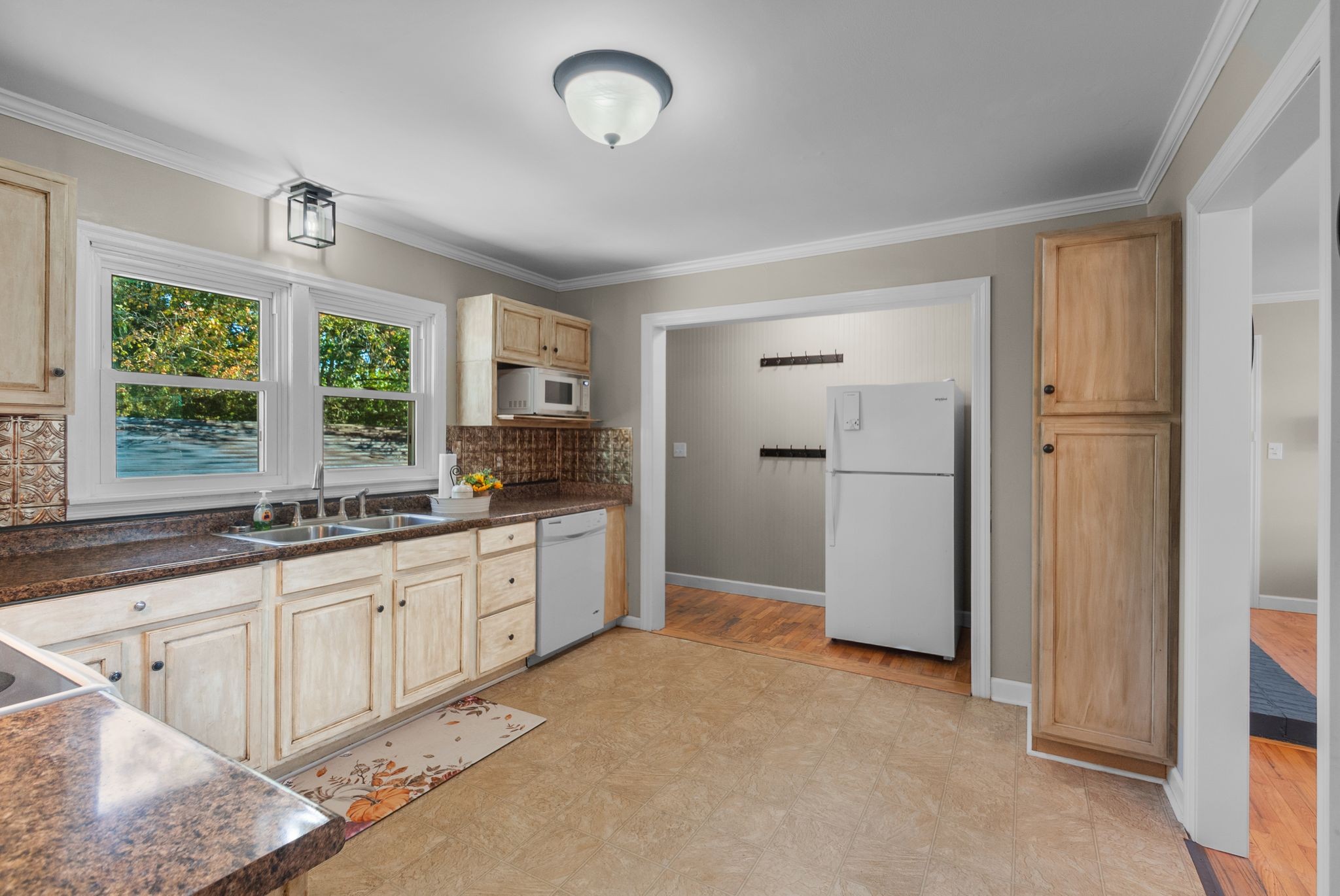 415 South Ingram Street Pulaski, TN 38478 - Photo 13 of 33 a large kitchen with a refrigerator a sink dishwasher a fireplace and a large window