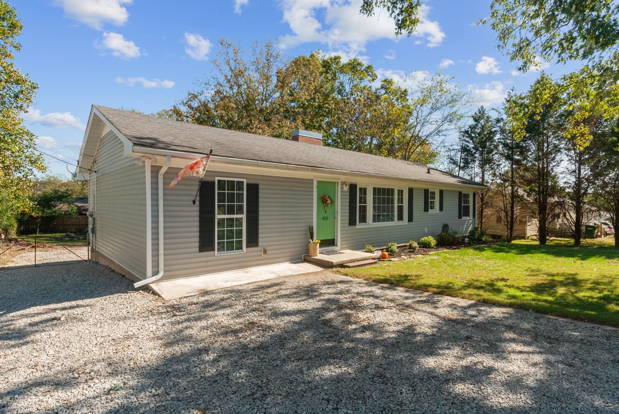415 South Ingram Street Pulaski, TN 38478 - Photo 2 of 33 a front view of a house with a garden and yard