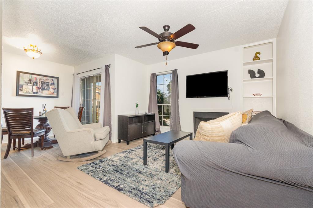 18333 Roehampton Drive, Unit 225 Dallas, TX 75252 - Photo 2 of 13 a living room with furniture and a flat screen tv