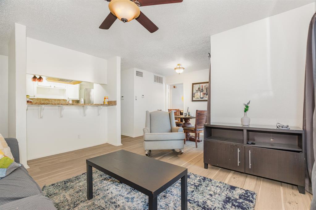 18333 Roehampton Drive, Unit 225 Dallas, TX 75252 - Photo 5 of 13 a living room with furniture and wooden floor