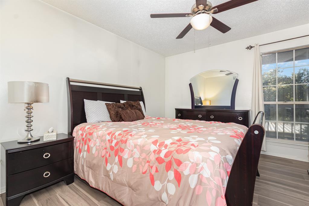 18333 Roehampton Drive, Unit 225 Dallas, TX 75252 - Photo 10 of 13 a bedroom with a bed and a mirror