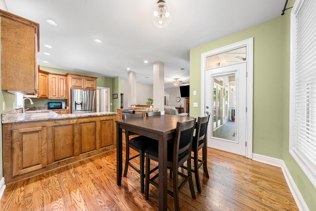 217 Maret Road Townville, SC 29689 - Photo 13 of 35 A harmonious open-concept design unites the kitchen, dining, and living areas with continuous wood flooring.