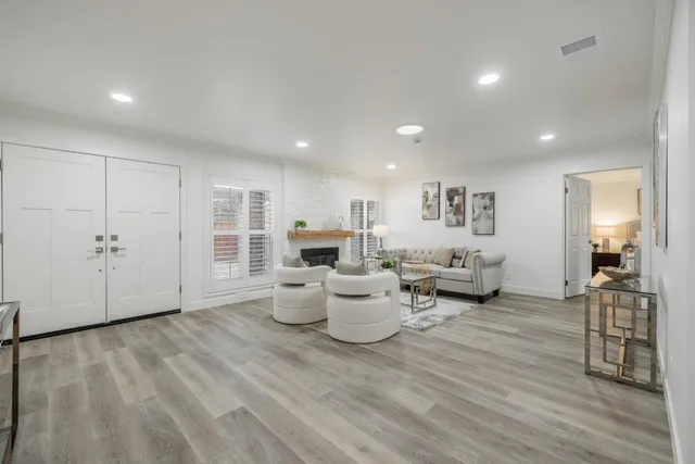 a living room with furniture and wooden floor