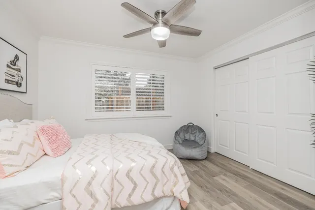 a bedroom with a bed and a window