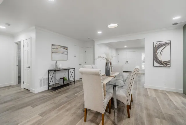 a view of a dining room with furniture and wooden floor