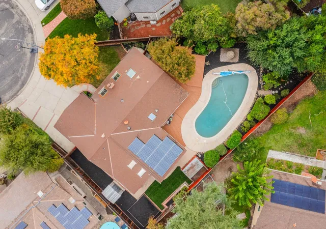 an aerial view of a house with a swimming pool