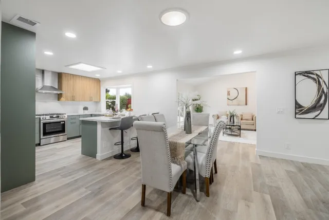 a view of a dining area with furniture and wooden floor