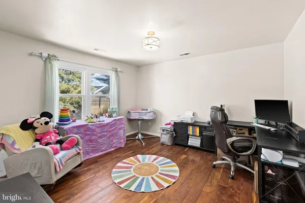 a bedroom with a bed and a ceiling fan
