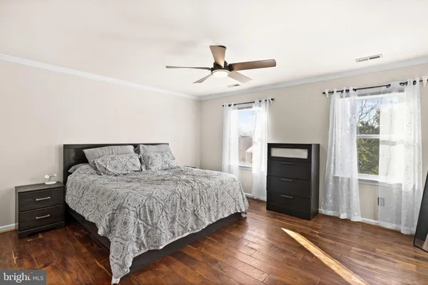 a bedroom with a bed and a ceiling fan