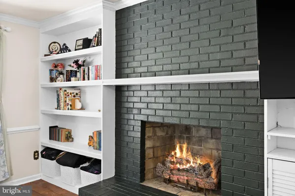 a room with fireplace and shelf