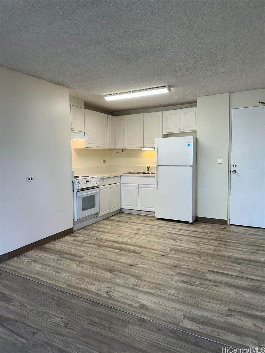 2651 Kuilei Street, Unit B21 Honolulu, HI 96826 - Photo 11 of 20 a view of a kitchen with wooden floor