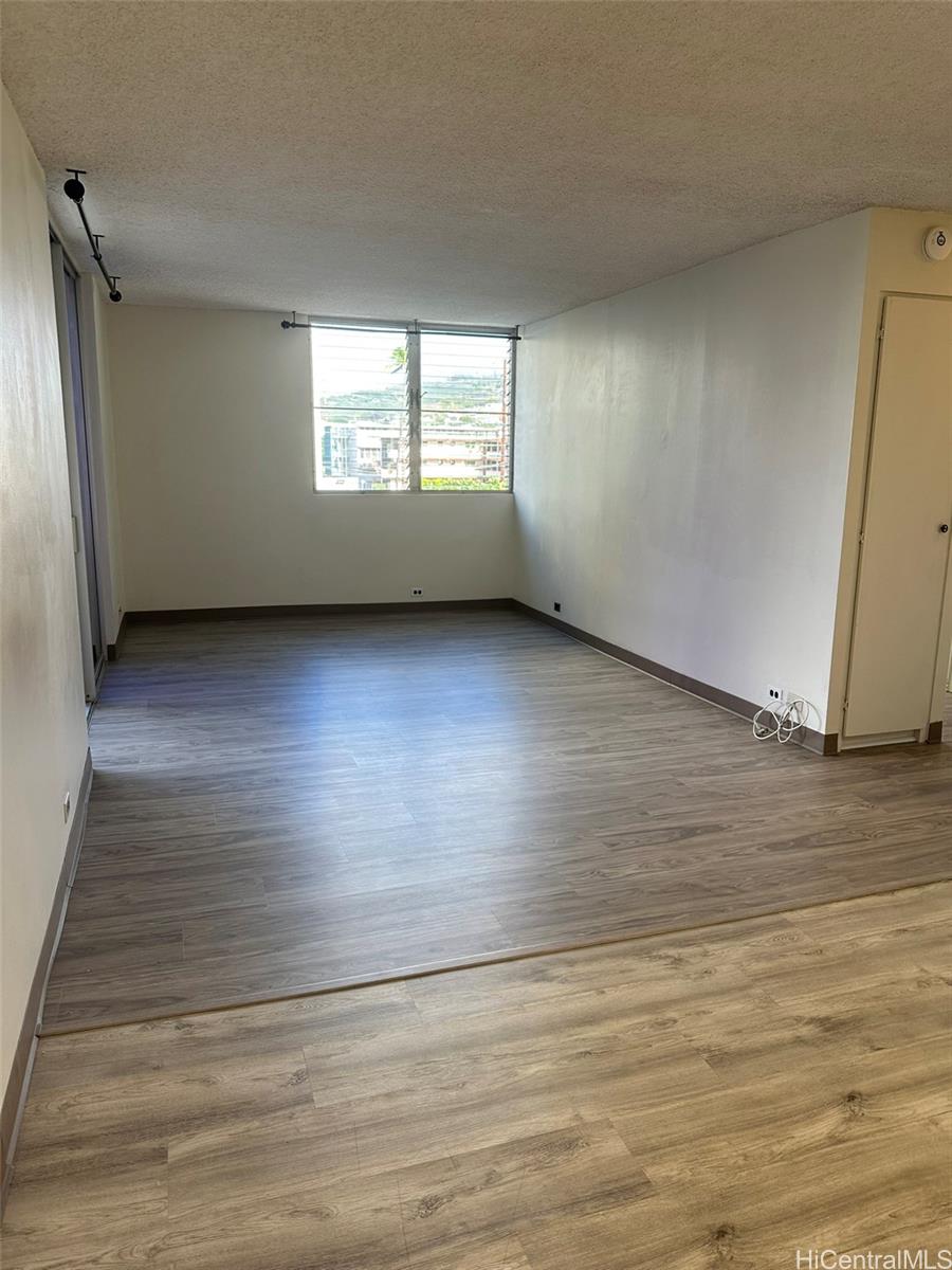 2651 Kuilei Street, Unit B21 Honolulu, HI 96826 - Photo 12 of 20 an empty room with wooden floor and windows