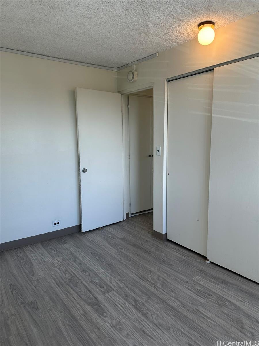 2651 Kuilei Street, Unit B21 Honolulu, HI 96826 - Photo 6 of 20 a view of an empty room with wooden floor