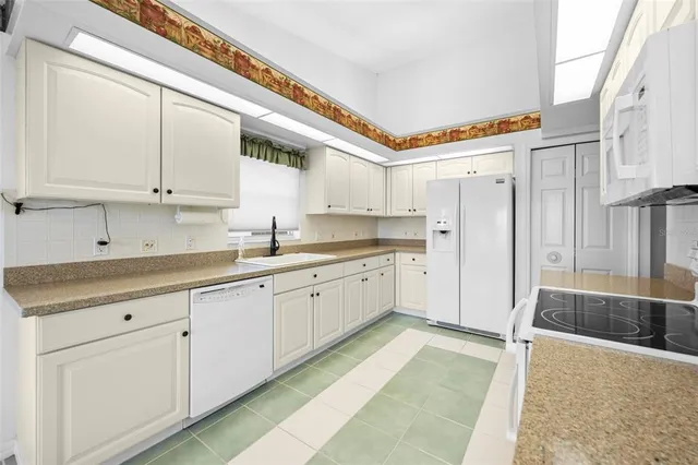a view of a kitchen with electric appliances