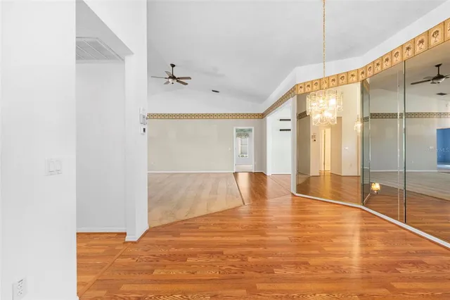 a view of a big room with wooden floor and staircase