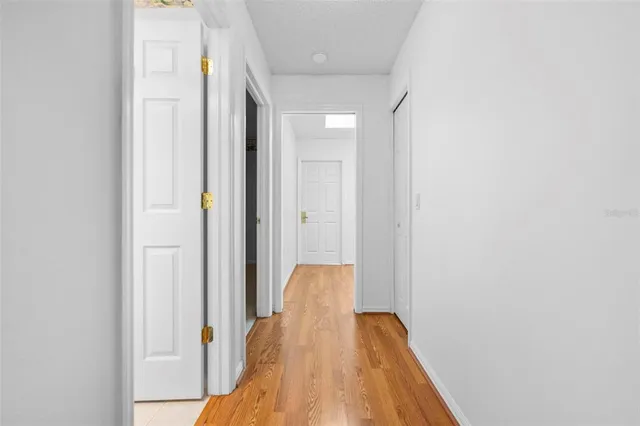 a view of an empty room with a ceiling fan and window