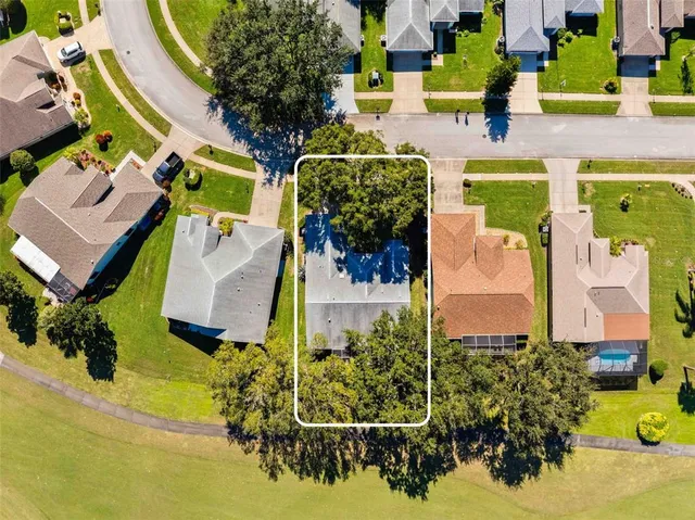 an aerial view of a houses with yard