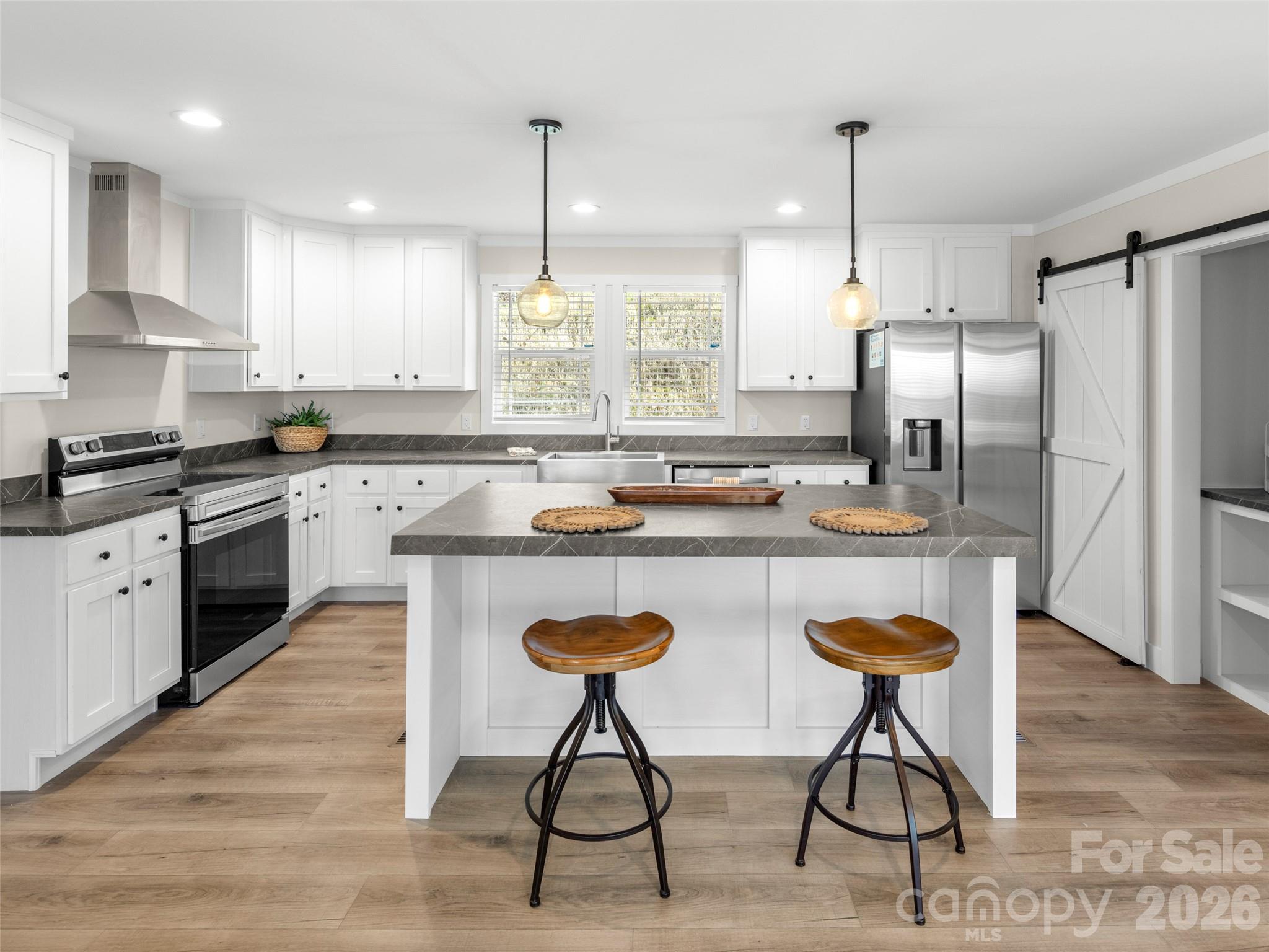 512 Hutch Mountain Road Fletcher, NC 28732 - Photo 1 of 23 a kitchen with stainless steel appliances granite countertop a sink a stove a refrigerator and island with wooden floor