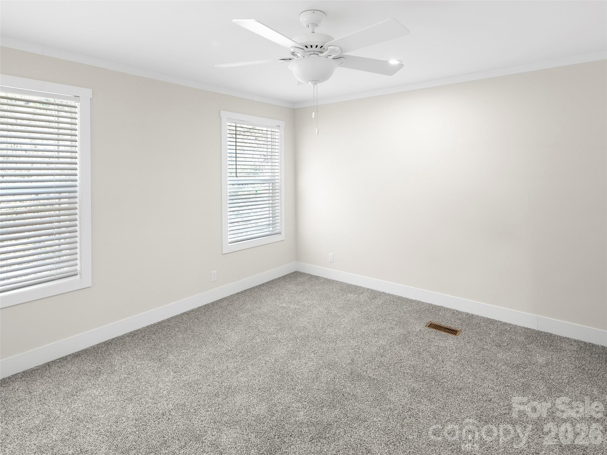 512 Hutch Mountain Road Fletcher, NC 28732 - Photo 14 of 23 an empty room with windows and ceiling fan