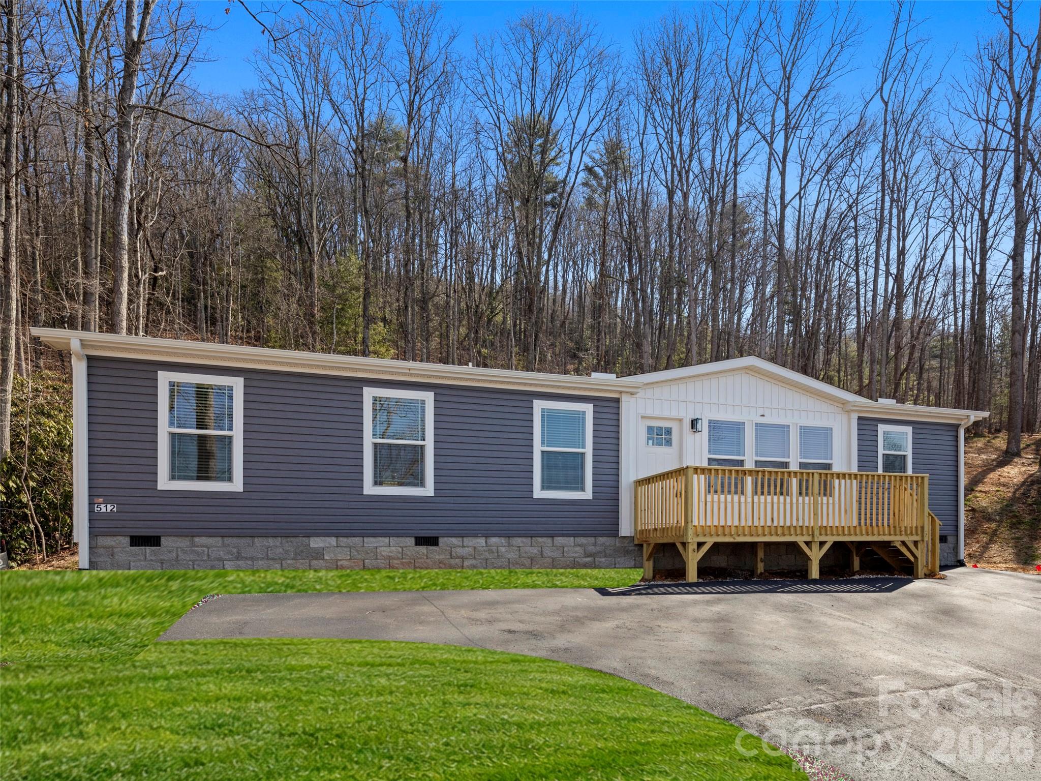 512 Hutch Mountain Road Fletcher, NC 28732 - Photo 3 of 23 a view of a house with a yard and large tree