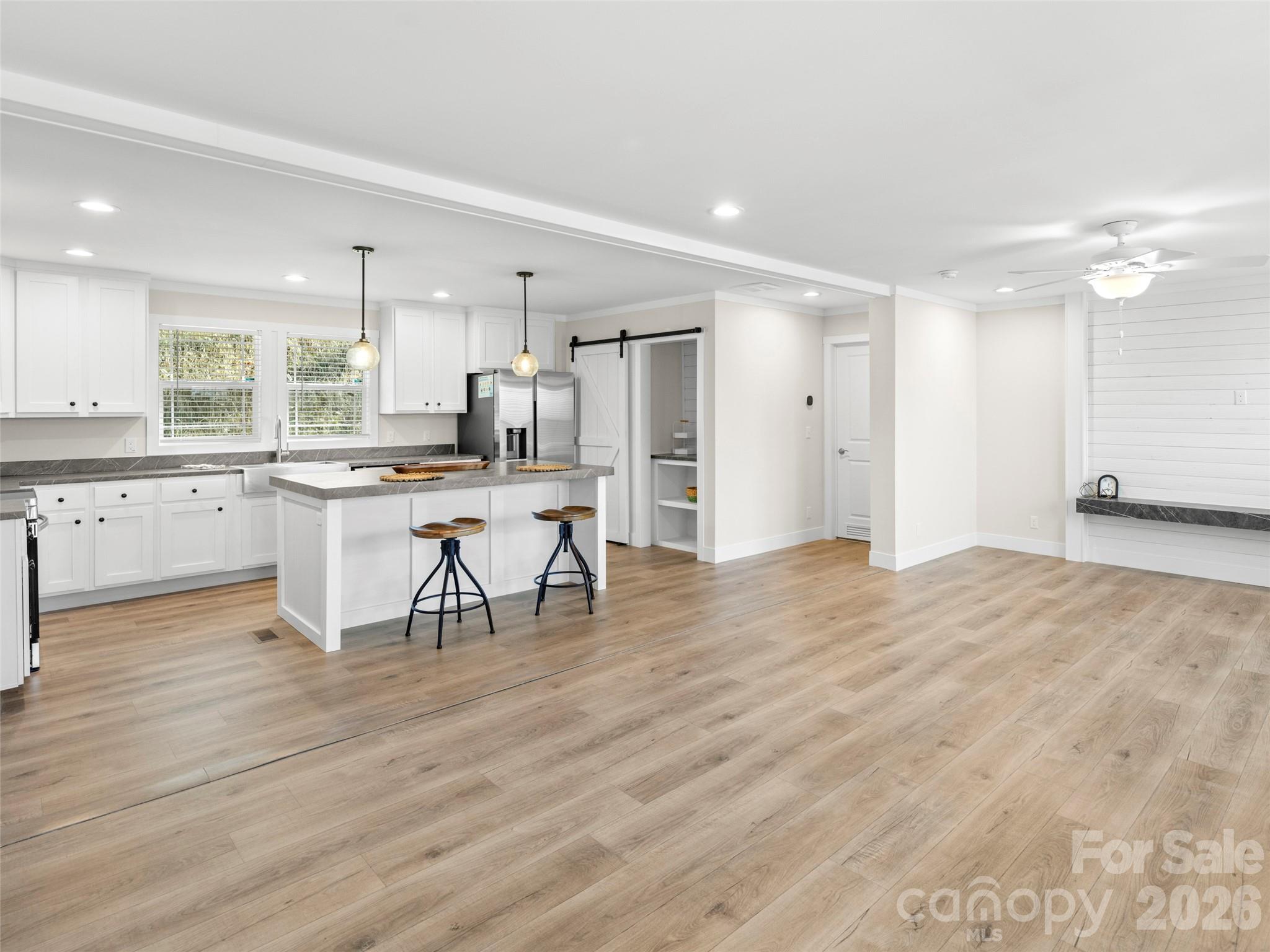 512 Hutch Mountain Road Fletcher, NC 28732 - Photo 6 of 23 a open kitchen with stainless steel appliances granite countertop a stove top oven a sink dishwasher and a refrigerator with wooden floor