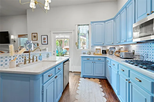 a kitchen with granite countertop a sink stove and cabinets