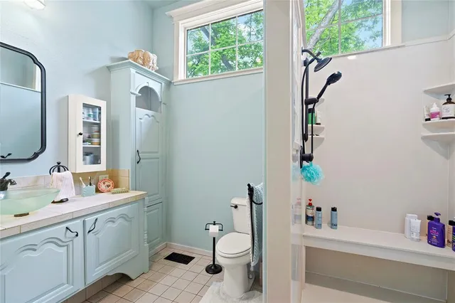 a bathroom with a sink mirror vanity and toilet